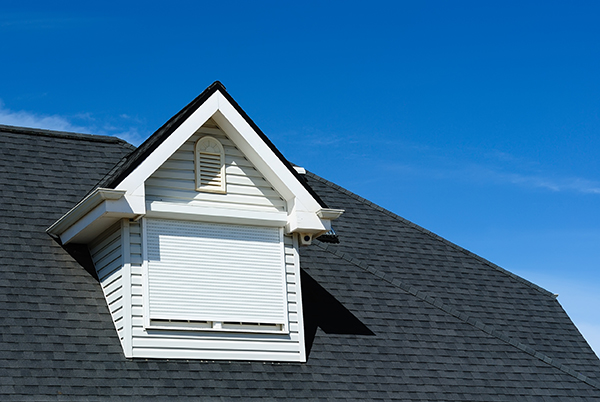 Attic window on the tiled roof